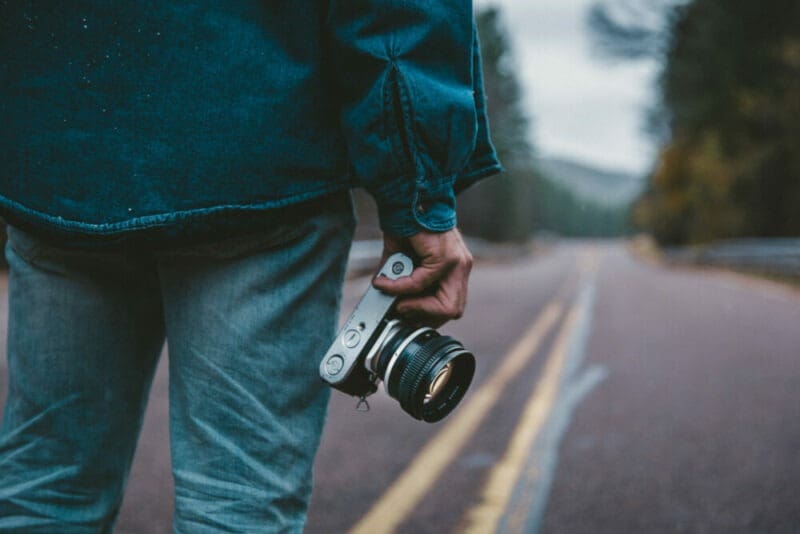 jean jacket person holding camera